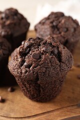 Delicious fresh chocolate muffins on table, closeup