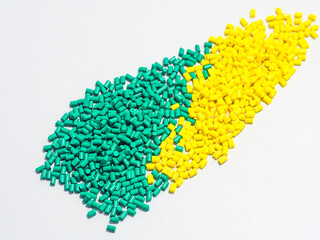 green and yellow masterbatch granules on a white background, coloring polymer for products in the...