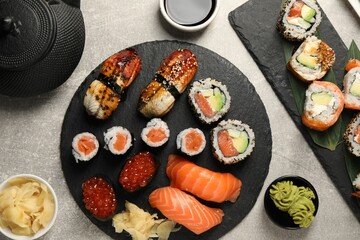 Flat lay composition with delicious sushi rolls on light grey table
