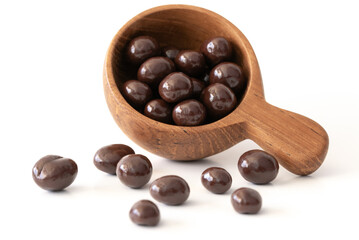 Chocolate Covered Coffee Beans Spilled from a Wood Scoop - 734432953