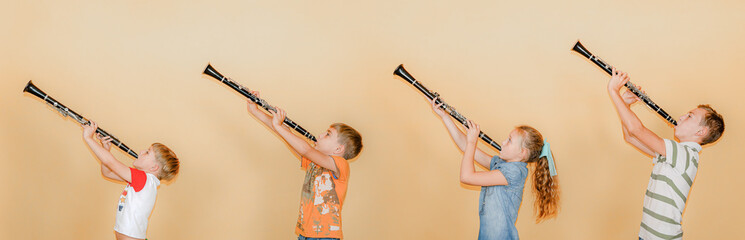 Four people, a musician, stand in a row and play clarinets, photos of children on a yellow background.