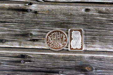 Translation of the Arabic text (O forgiver of transgressions), Islamic pure silver ounce coin and  another silver ounce bar, The price of silver is driven by speculation, supply and demand