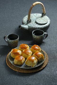 A plate of Bakpia tape, traditional snack from Yogya on green background. Made from cassava fermented, flour, butter abd sugar. Bakpia tape