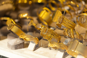 Jewelry shop window with a huge selection of gold jewelry bracelets, chains
