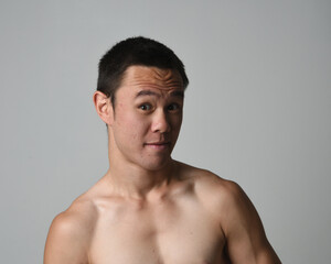 Close up portrait of asian male model, expressive and  exaggerated  facial expressions and silly faces. Isolated on a white studio background 