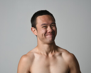 Naklejka premium Close up portrait of asian male model, expressive and exaggerated facial expressions and silly faces. Isolated on a white studio background 