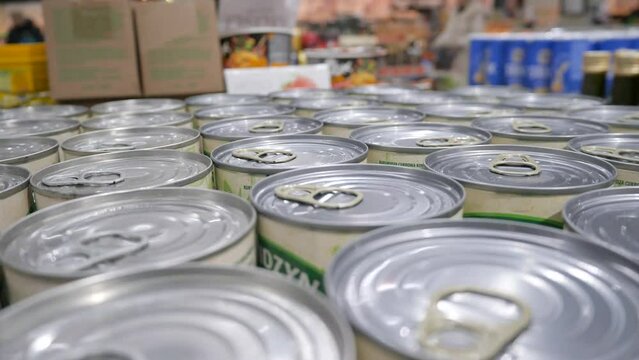 Lots of cans of canned food in the store.