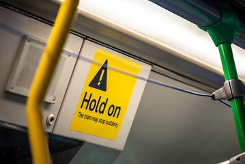 A yellow 'Hold On' sign onboard a famous Melbourne tram that often move suddenly and unexpectedly....