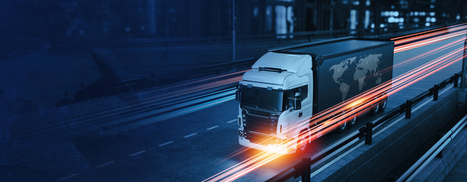 Trucks are running on the city highway at night.