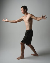 full length portrait of fit asian male model, shirtless with muscles.  gestural ti chi inspired...