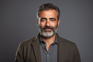 Obraz premium Handsome middle-aged man with beard and mustache. Gray background.