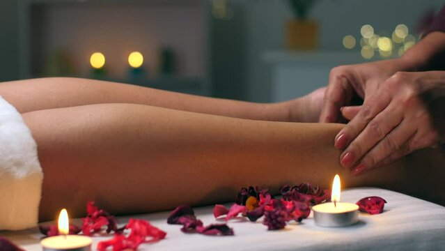 Female masseuse massaging the legs of a client in a relaxed and calm atmosphere - spa center  healthy body and skin  self-love care. Anti-cellulite massage in the Ayurvedic center - oil massage  re...