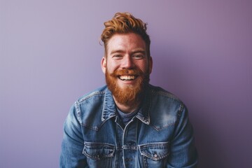 Obraz premium Portrait of a red-bearded hipster man on a purple background