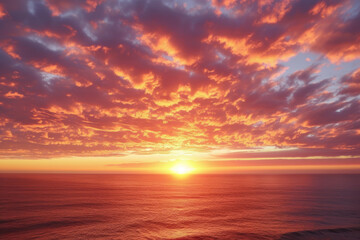 Obraz premium sunset over the ocean, with orange and pink clouds in the sky