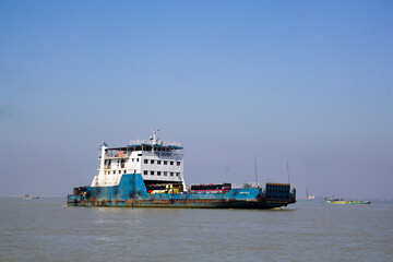 Boat on the River.  Bus and people are crossing from one side of the Padma River to the other by ferry.