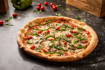Veggie Pizza topping with cherry tomato, mushroom, capsicum and coriander isolated on dark background with raw food top view of italian fastfood appetizer