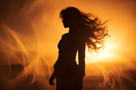 A photograph of a powerful woman standing against a golden sunset backdrop, capturing her strength and determination.