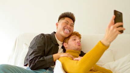 Tender gay couple taking a selfie at home
