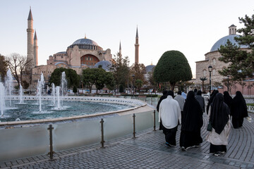 View of Hagia Sophia from Sultanahmet Park in Istanbul, Turkey. Initially a 6th-century church, it underwent transformations into a mosque, then a museum, and was officially reconverted in 2020. - obrazy, fototapety, plakaty