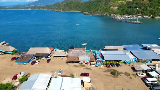 Aerial drone footage advancing towards the sea over the bustling Vicente Guerrero Port, Guerrero State