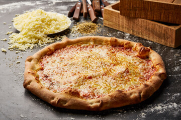 Plain Cheese Pizza isolated on dark background with raw food top view of italian fastfood appetizer