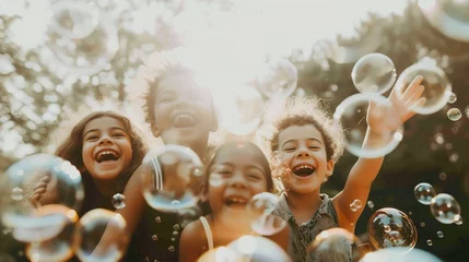 Fotobehang Multi-ethnic group of little friends with toothy smiles on their faces enjoying warm sunny day while participating in soap bubbles show © Jennifer
