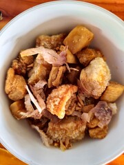 Thai Boat noodles in thicken soup added blood with Pork balls, Sliced beef and liver serve with basil and crispy fried pork skin.