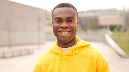 An african young man standing and smiling