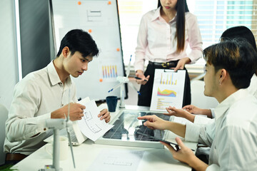 Group of engineers discussing a new project during a meeting in the office. Renewable energy concept