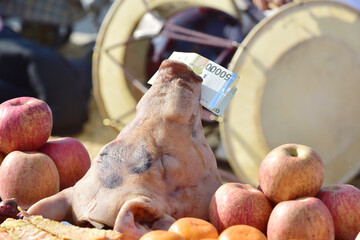 Korean bills and pig head on ancestral rites ceremony table