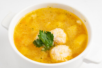 soup with meatballs on white background