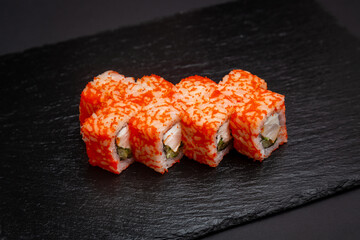 Sushi, California rolls with cucumber. On a black background.