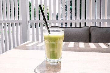 Cold matcha tea on a table in a cafe. Summer cold drinks.