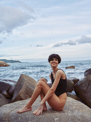 Fototapeta na wymiar Pretty female model enjoying freedom and relaxation at the sunny beach by the serene ocean
