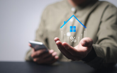 Real estate investment concept. Person holding  house and up arrow icon on virtual screen for...