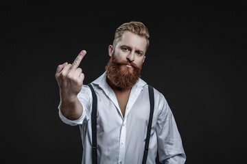 Vintage brutality guy showing middle finger in retro suspenders. Retro man in suspenders isolated...