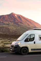 Vertical view ofSunset Glow on a Van Traveling Near a Mountain in Teide, Tenerife - obrazy, fototapety, plakaty
