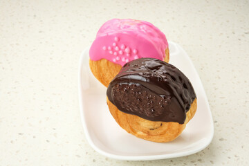 Cromboloni or Crombolini, croissant bomboloni pastry filling with chocolate paste
