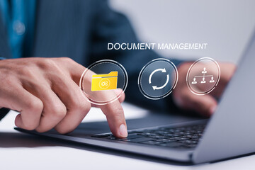 Document management concept. Businessman use laptop with electronic documents on virtual screen for...