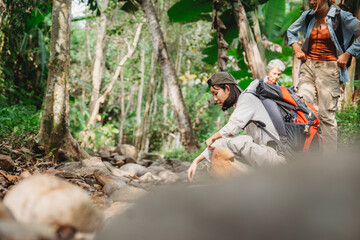 Young female backpacker group traveling in wild forest, Attractive girl traveler look around and explore while walk in nature wood with happiness and fun during holiday vacation trip.