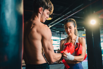 Active, athletes and fit men kick boxing and doing sport training workout in a gym. Two male partners or MMA boxer and trainer practice sparring exercises for a healthy wellness lifestyle.
