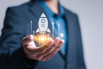 Startup business concept. Strategic planning and business success. Businessman holding rocket icon...