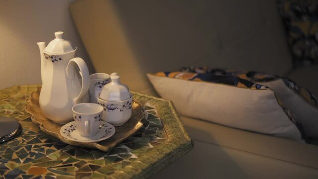 Cozy teatime setup with mosaic table and cushion