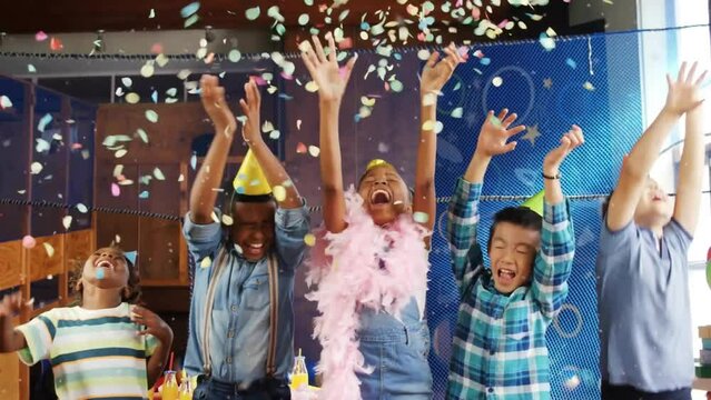 Animation of confetti over happy diverse children having fun with balloons at birthday party