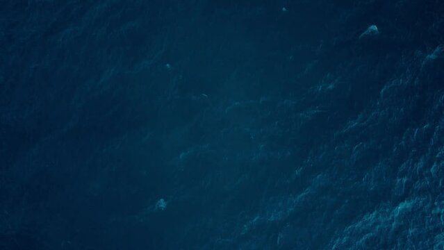 Deep blue ocean textures from a high vantage point, waves creating subtle patterns