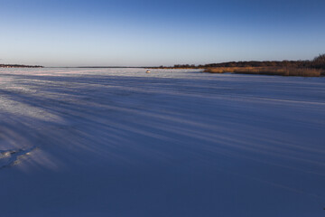 Winter view of the Quebec with a sunset on the frozen St. Lawrence river.