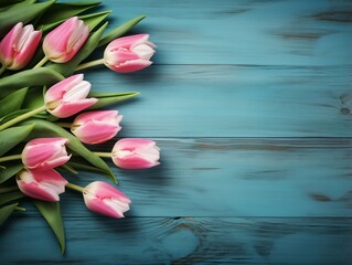 Tulips on wooden table with blue wooden background and copy text space