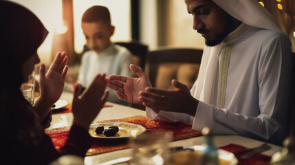 Muslin family praying before ramadan supper - obrazy, fototapety, plakaty