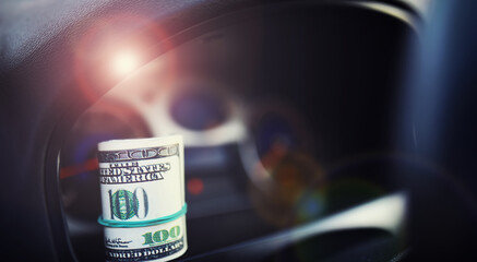 Concept background. dollars with a car key lie in inside cars. financial concept