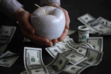 Apple on table with money, dollars banknotes. Us business concept. 